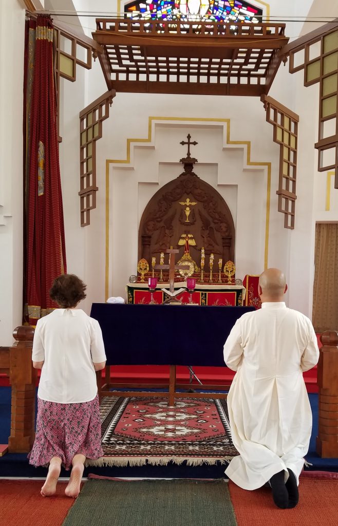 Anne and Fr. Chas Canoy praying in the chapel of the seminary CROPPED